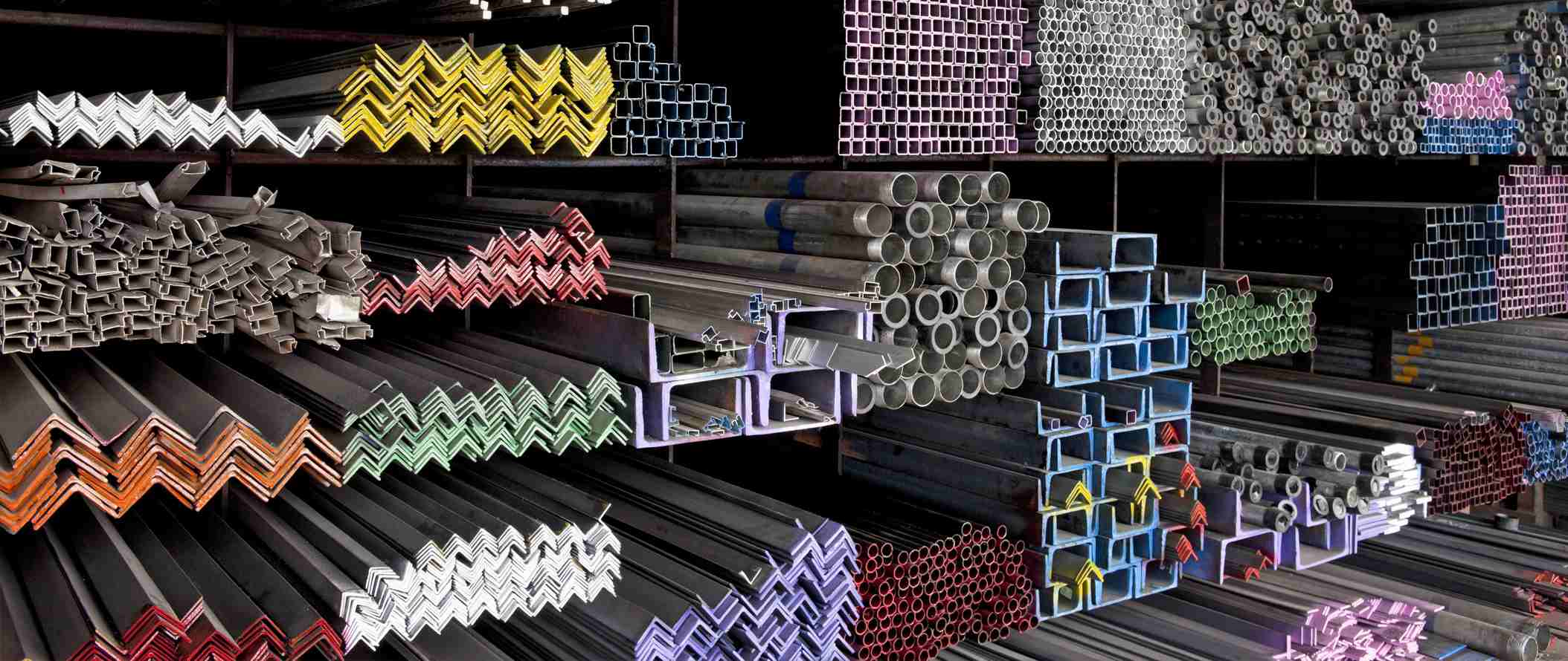 Various angle iron profiles and steel rods kept in storage shelves in a steel shop